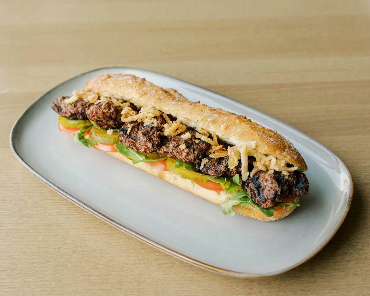 The Hungry Odin handmade Turkish köfte sandwich with fresh toppings and crispy onions